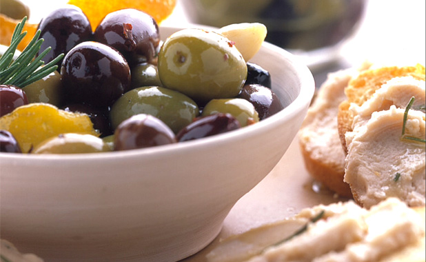 Locally harvested olives and humus on toasted bread