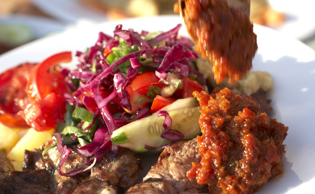 Kebab plate with salad and Ezme, a spicy tomato tapenade.