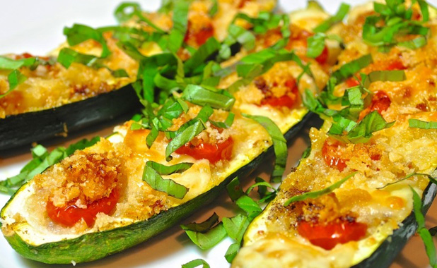 Courgettes filled with tomato and cheese, and grilled for a crunchy crispy topping